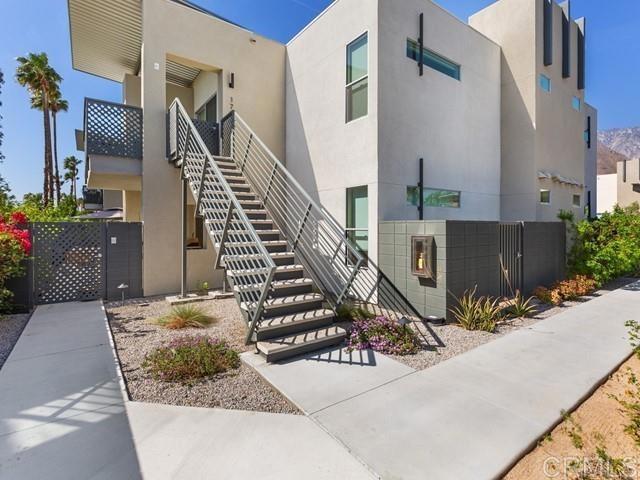 Modern, stylish upper condo! This bright and beautifully appointed 2 bed / 2 bath upper-level open floor plan condo at 64@The Riv offers incredible value in Palm Springs. Fully furnished with sleek West Elm pieces, this newer construction home features an open floor plan with soaring 9' ceilings, floor-to-ceiling windows, and a spacious kitchen equipped with quartz counters, stainless steel appliances, and an island for easy entertaining. The eastern exposure brings in soft morning light through lush greenery, creating a peaceful and private setting. You'll love the spa-like bathrooms, new washer/dryer, window treatments, and a private patio with storage. Residents enjoy resort-style amenities including a 60’ pool and spa, fire features, outdoor lounges, BBQs, gated dog park, and breathtaking mountain views. Covered carport parking, guest spaces, and community EV charging make life here easy. Located near Desert Regional Medical Center, Uptown Design District, and a short stroll to downtown Palm Springs