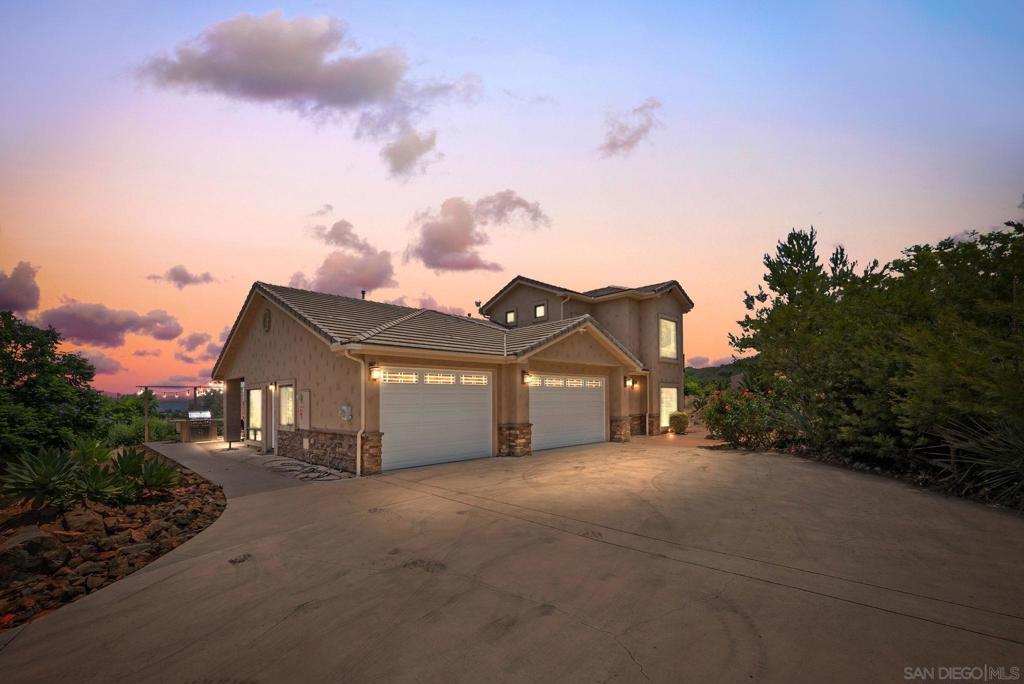 Welcome to your ultra-PRIVATE oasis on a spacious 4.32-acre lot in the heart of Valley Center. Refined country living with this exceptional estate, where timeless craftsmanship meets modern convenience. Nestled on a sprawling, private lot, this one-of-a-kind property offers serene surroundings, rolling hill views, spacious design, and elegant upgrades throughout. Inside, you'll find engineered hardwood floors, custom-crafted wooden door frames, and plantation shutters that exude charm and sophistication. The primary suite is conveniently located on the main level with a walk-in closet, offering comfort and privacy, along with a dedicated home office ideal for remote work or creative pursuits. Upstairs, you’ll find two spacious guest bedrooms, an open loft area perfect for a media room or second living space, and two scenic balconies, one that overlooks the surrounding countryside and one private area. The expansive layout seamlessly connects indoor comfort to outdoor luxury, with two entertainer’s patios, a private jacuzzi spa, and lush, manicured landscaping featuring blooming rose gardens and mature trees. Designed for both relaxation and functionality, the property boasts RV parking, solar system, newer tankless water heater, newer HVAC, soft water system, built-in BBQ, a 4-car garage, and three versatile sheds for storage, hobbies, or a future studio space. This is more than a home - it’s a lifestyle. Conveniently located near new retail and shops by Park Circle! Whether you're hosting guests under the stars, tending your garden, or enjoying quiet mornings in the countryside, this Valley Center gem offers a rare opportunity to live with both elegance and ease.