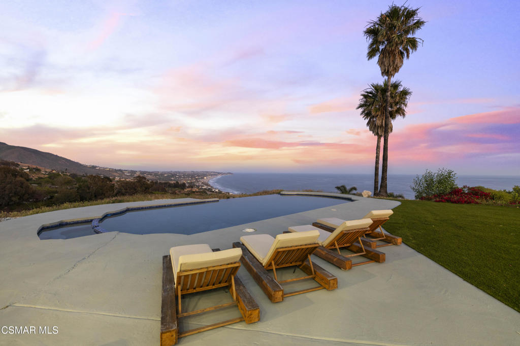 Welcome to your own private Malibu resort--an extraordinary five-bedroom, six-bathroom estate perched above Pacific Coast Highway with beautiful panoramic views of the best beaches in Malibu, and the surrounding mountains. Set on an expansive 4-acre compound, this breathtaking property embodies the essence of coastal California luxury, combining privacy, elegance, and endless potential in one of Malibu's most coveted locations. From the moment you enter, you're greeted by sweeping ocean vistas that pour through oversized windows, filling the home with natural light and a constant reminder of the stunning beauty that surrounds you. Whether you're lounging in the living room, preparing meals in the gourmet kitchen, or waking up in the primary suite, the Pacific Ocean is your daily backdrop. Outside, the resort-like grounds offer everything you could imagine for both relaxation and recreation. The pool and spa area boast some of the best views in Malibu--perfect for entertaining or enjoying a peaceful sunset. A private tennis court adds to the estate's allure, while manicured lawns and lush landscaping create a serene, secluded ambiance.Nearby world-class hiking trails invite you to explore Malibu's natural beauty, offering endless adventure just minutes from your front door. Adding even more value and versatility, the sale includes additional adjacent parcels that provide room to expand, build a guest house, or develop your dream amenities--offering a rare opportunity to own a true legacy property. This is more than a home--it's a lifestyle. A peaceful sanctuary just minutes from the heart of Malibu, world-class surfing, hiking trails, restaurants, and top-tier schools. Whether you're seeking a luxurious full-time residence, a family compound, or an elite vacation retreat, this estate delivers on every level. A once-in-a-lifetime offering in prime Malibu. Paradise found.