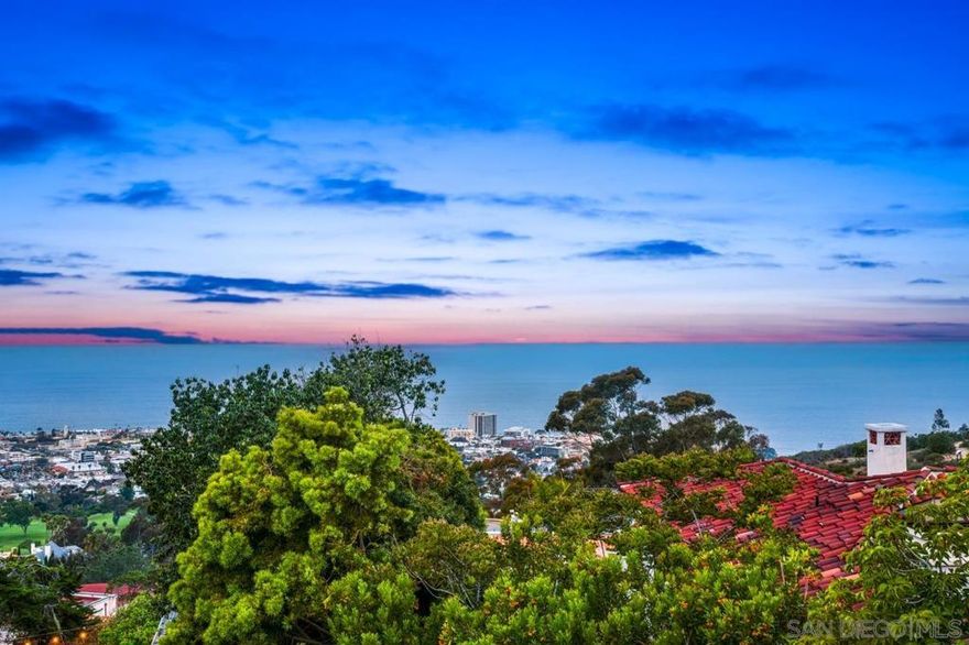 The Laureate House A Legacy of Art, Architecture, and Awe-Inspiring Views Perched above the La Jolla Country Club with sweeping panoramic vistas of the Pacific Ocean and The Village below, The Laureate House is a once-in-a-lifetime offering—an enchanting Spanish Colonial Revival estate that radiates history, beauty, and soul. Lovingly owned by Nobel Prize-winner and This rare jewel bears the hallmarks of Southern California Spanish Architecture that is  iconic & holistic and was inspired by the vernacular of early California and Mexico, she infused the home with warmth and elegance—whitewashed stucco walls, red-tile roofing, wrought iron details, and intimate garden spaces that invite harmony with the landscape. The home’s layout is centered around a serene courtyard anchored by a reflection pond, evoking the romance and simplicity of a bygone era. Five spacious bedrooms, three full bathrooms, and two powder rooms are gracefully woven into a floorplan that encourages both celebration and contemplation. Indoor and outdoor living flow seamlessly, with grand entertaining areas opening to lush ocean-view terraces and a backyard ideal for gatherings under the stars. Rich in provenance and architectural character, this is not just a home—it is a legacy. A place where history, art, and nature converge in one of La Jolla’s most storied and breathtaking settings.