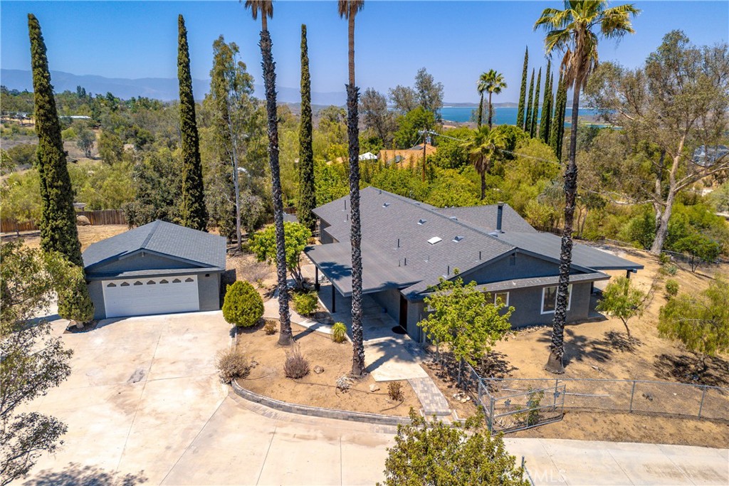 Charming Ranch-Style Home with Stunning Views. Plenty useable land for farm animals and horses located on a quiet cul de sac. This lovely ranch-style property is a perfect blend of comfort and natural beauty. Featuring three spacious bedrooms and two bathrooms, this home also includes an oversized two-car garage. Situated in a serene location, you’ll enjoy breathtaking views of city lights, the valley, mountains, and even a lake. Plus, it’s ideally located within the highly-rated Corona-Norco school district and is just moments away from the latest and greatest shopping destinations. The expansive lot provides ample space for horses and gardens, making it a dream for nature lovers and outdoor enthusiasts. Whether you want to cultivate your own garden, have space for animals, or simply enjoy the open air, this property has it all. As you step through the front door, you'll be greeted by a bright and airy formal living area—perfect for a second family room, game room, or whatever suits your needs. Large windows flood the space with natural light and offer stunning views of the surrounding landscape.
The well-appointed kitchen opens up to the cozy family room, making it ideal for entertaining. With plenty of cabinet space and countertops, the kitchen is both functional and welcoming. The family room features a charming fireplace and sliding doors that lead to a covered patio and a spacious backyard. The primary bedroom is a peaceful retreat, complete with an ensuite bathroom. The entire home boasts beautiful tile flooring, providing a sleek, easy-to-maintain finish throughout. Both of the secondary bedrooms are generously sized, and the updated guest bathroom offers modern touches. Additional updates include newer double-pane vinyl windows and a brand-new roof, giving you peace of mind for years to come. There’s plenty of potential here, with room to add a larger garage, a pool, or even a second living unit. The covered front and rear patios extend your living space outdoors, offering ideal spots for relaxing or hosting gatherings.