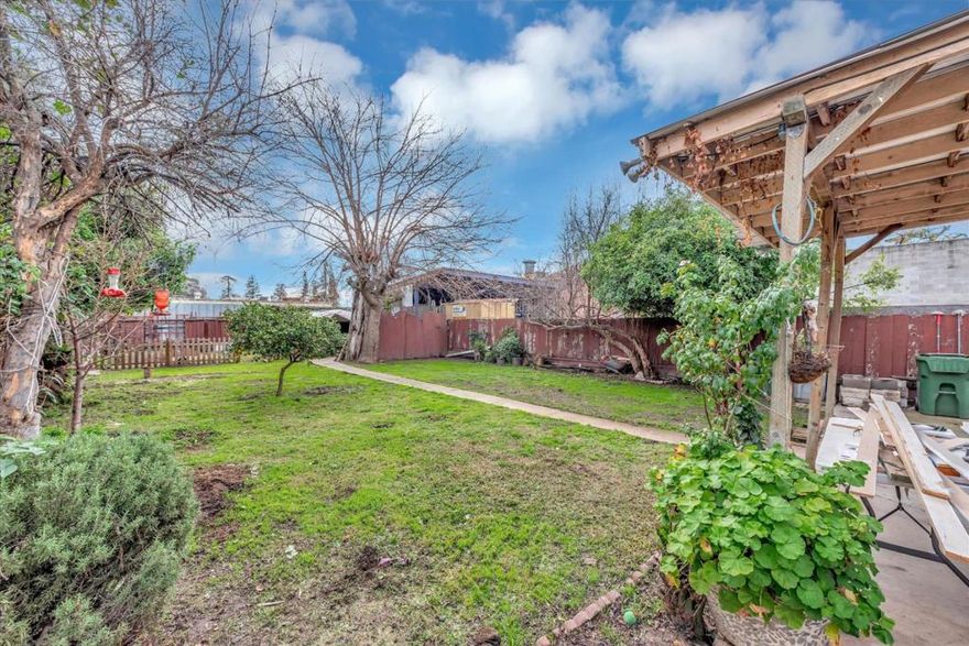 Single story single family home with long side driveway for backyard easy access. th a show room or work room.  Offers a  a kitchen and bathroom and large level backyard with  7,841 sf lot i  The home is approx 1,060 sf with 3 bedrooms 1.5 baths.  Has deferred maintenance.