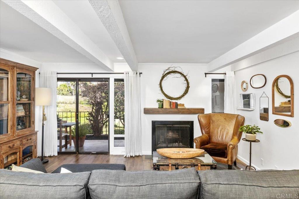 Showing as a 2-bedroom, this rare single-level, turn-key end unit could be yours. Perfectly located in the heart of La Costa-just minutes from the beach-this home overlooks the 3rd hole of the Omni La Costa Golf Course with gorgeous, uninterrupted views. Every inch of this open-concept retreat has been thoughtfully upgraded and is truly move-in ready: luxury vinyl plank flooring, Carrera marble countertops in the kitchen, Carrera marble floors in both bathrooms, and added storage throughout set the tone for elevated living. The living room is anchored by a wood-burning fireplace. With western exposure, the home is filled with immense natural light, while three sets of sliding doors open to an expansive, private patio, creating the perfect backdrop for quiet mornings or sunset toasts. The stunning kitchen with stainless steel appliances and a farmhouse sink is designed for both barefoot baking and intimate dinner parties. The primary bedroom features two custom built-in closets, while the en-suite includes an oversized dressing area, traditional closet, a secondary closet, and in-unit laundry. In addition to the office nook a 2nd room added as a bedroom could be your next big idea - library, studio, meditation space you decide. Upgraded doors, trim, hardware, lighting fixtures, ceiling fan, custom mantle and HVAC to boot. Two designated spaces, community pool, jacuzzi, and sauna - boutique shops, and restaurants around the corner. Translation: beach walks, great schools, swims, spritzes, and sourdough starters are all within your orbit. If you’re already picturing yourself here…yeah, so is everyone else.