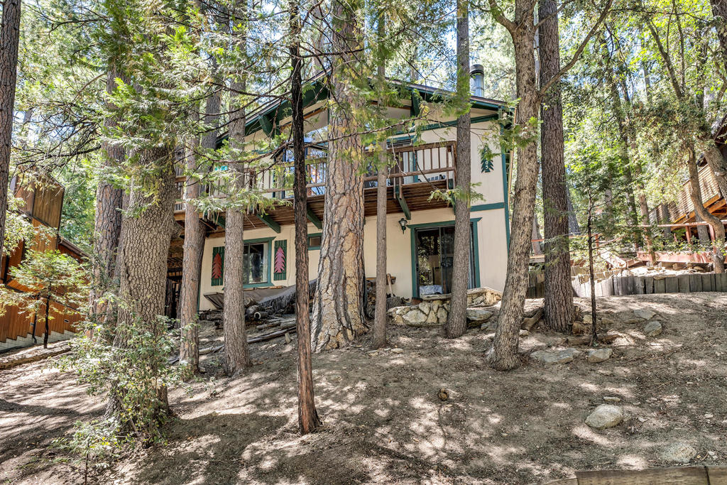 Welcome to a Beautiful, Peaceful, Tree House.Upon entering, you'll find a welcoming living room featuring a large bay window that frames stunning views of the forest. A cozy wood burning fireplace adds warmth and ambiance, complemented by a dining area ideal for entertaining guests. A convenient half bath is also located on this level for added comfort. Downstairs, discover two bedrooms and a full bath, providing ample space for relaxation and privacy. The lower level also includes a washer and dryer. Step outside to multi-level decking that seamlessly extends your living space into the great outdoors, offering the perfect spot for morning coffee or evening gatherings. The property features two storage sheds, providing abundant space for all your outdoor equipment and personal belongings.This home, with its enchanting setting is an idyllic haven to unwind and embrace the beauty of nature. Experience the tranquility and charm of this home today-your perfect escape awaits.