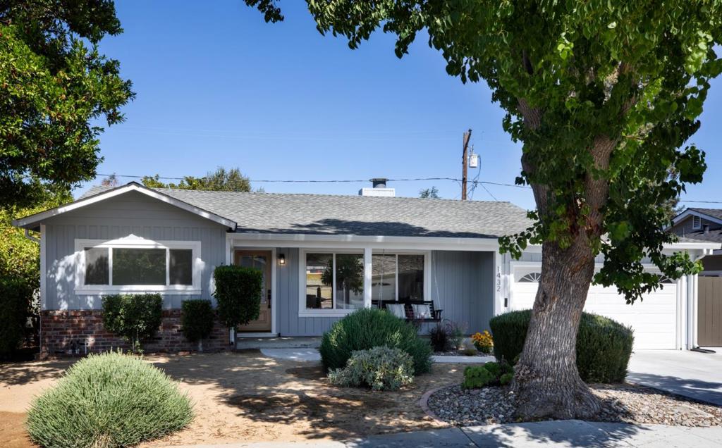 Welcome to this warm single-level home in the peaceful St. Francis Acres neighborhood with Los Altos Schools. A classic ranch-style with modern updates, it features a charming covered porch, brick accents, and a wide picture window that fills the living room with light. Inside, the open layout flows from the inviting living room with fireplace to the dining area and updated kitchen with stainless appliances, gas range, hood, and abundant cabinetry. The mudroom offers custom storage, bench, and hooks for everyday ease. In the bedroom wing, two bright bedrooms share a full bath, while the spacious primary suite boasts a large closet and private ensuite. Step outside to a low-maintenance yard with space for gardening, play, or relaxing, plus a finished workshop perfect for a studio, office, or playroom.