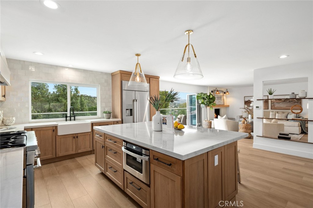 Motivated Seller! Another Price Drop! Panoramic View home with attached ADU. Rental opportunity of $4K/MO in downstairs ADU. This 3,950 SF home is positioned on a premium street to street hillside lot with multiple entertaining areas in the coveted and highly sought-after Panorama Heights. This stunning home is “Pinterest Perfect” and completely remodeled by a local well-known interior designer. Ideally located on the hill with plenty of parking which can be difficult to obtain in hillside neighborhoods. In addition to the 3-car garage, there is a private 3-car parking pad adjacent to the home. This gorgeous house was designed with contemporary on-trend features and upgrades. Organic and cohesive blends of natural materials throughout, while stellar unobstructed views, multiple decks, and tranquil landscape create an inviting outdoor vibe. The main living area open concept floorplan showcases the high-end design features including multiple sets of brand-new folding doors to accentuate the views, top of the line Thermador and Dacor appliances, custom tile and built-ins and a main floor bedroom and full bathroom. No stone has been left unturned with careful thought and attention to detail in every aspect of this spectacular property. The chef’s kitchen overlooks that incredible view and flows seamlessly out onto the deck. Upstairs, savor the serenity of the primary suite, which boasts a luxury spa-style bathroom and spacious walk-in closet with yet another deck adjacent to the bedroom. Two additional bedrooms, loads of storage and another full bathroom complete the upper level. The lower ADU level is complete with a kitchen, family room, dining area, two more bedrooms, full bathroom and additional powder room. Great for in-laws, kids returning from college for a stay or your out of town guests! This premium location is just 15 minutes from Orange County airport, 25 minutes to Newport Beach, 40 minutes to downtown LA and 5 minutes to Peters Canyon Regional Park, known for its miles of hiking and bike trails. Choice of the excellent award-winning Orange schools or the Tustin schools Arroyo, Hewes and Foothill.
