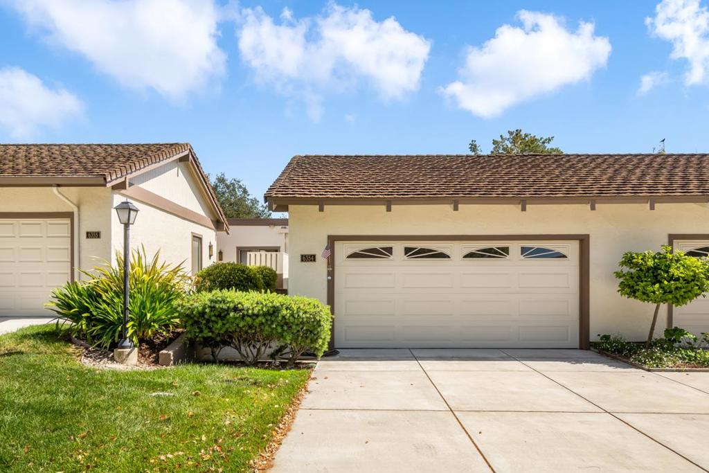 Well-maintained townhouse in the acclaimed The Villages Golf & Country Club, a 55+ community tucked in the Evergreen foothills. The heart of this unit is a sunlit living room with gorgeous exposed beam vaulted ceiling, a sliding patio door allows access to a raised deck that makes indoor/outdoor entertaining a breeze. There is a dining area separating the living room and an extra spacious galley kitchen with custom cabinets and updated appliances. You will find a bonus sunroom that encompasses the primary entry area, which can be used as a covered dining area or outdoor workout studio. Two generously sized bedrooms with accommodating bathrooms finish off the living space of this unit. Central air and heat keep its occupants comfortable throughout the year. Attached 2-car garage with full-sized, and brand new washer/dryer, and plenty of built-in storage. Enjoy all the benefits of The Villages Golf & Country Club with this fantastic townhouse tucked away on one of the quieter streets of the community. Just a short walk or drive to the proshop, main clubhouse, tennis courts, pickleball courts, pool and more!