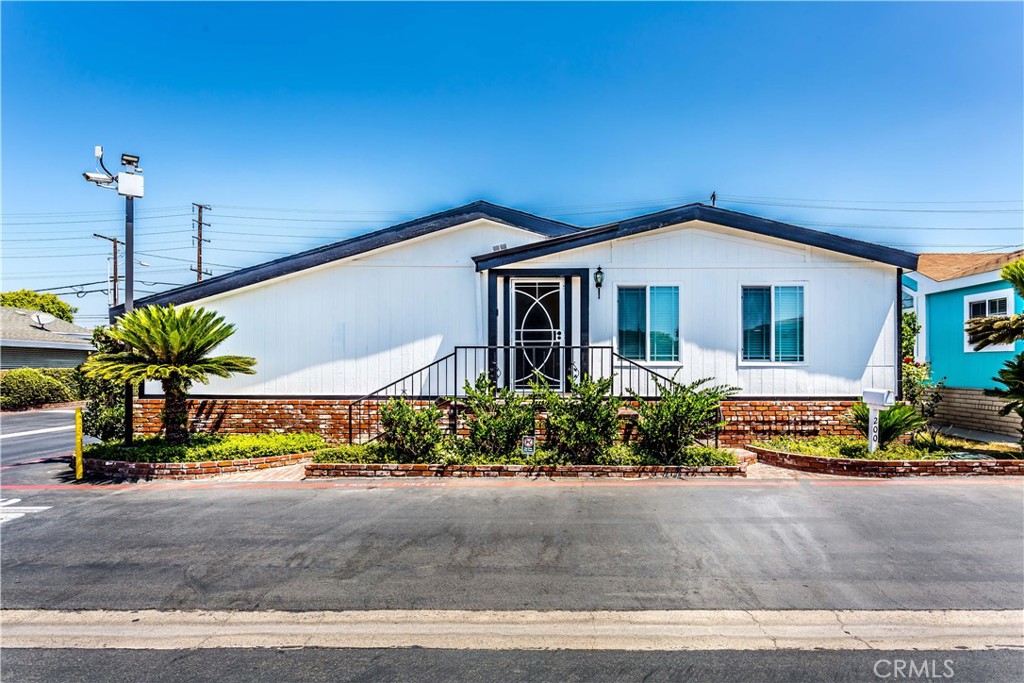 This beautiful spacious triple-wide mobile home with cathedral ceilings is now for sale! Boasting approximately 1,814 sq feet of living space, this home features 3 Bedrooms and 2 Bathrooms, along with 2 additional rooms that can be used as office or study rooms. As you step inside, you will be welcomed by an open living room area with recessed lights. The kitchen area is open and inviting, with a pantry, dining area and cozy fireplace. A sliding door leads to a spacious enclosed covered patio, perfect for hosting family gatherings. The house includes a 2 car garage with direct access to the house and laundry inside the garage. With vinyl flooring throughout, recessed lights, double pane windows and a brand new roof, this house is move in ready. Located in a prime location close to dining, shopping, freeways and attractions like Knotts Berry Farm and Adventure City, this home is waiting for you to call it home. Don't miss your chance to make this house yours today.
