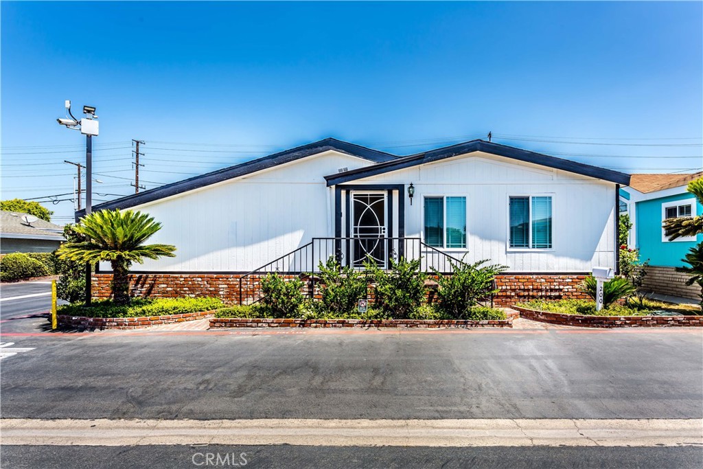 This beautiful spacious triple-wide mobile home with cathedral ceilings is now for sale! Boasting approximately 1,814 sq feet of living space, this home features 3 Bedrooms and 2 Bathrooms, along with 2 additional rooms that can be used as office or study rooms. As you step inside, you will be welcomed by an open living room area with recessed lights. The kitchen area is open and inviting, with a pantry, dining area and cozy fireplace. A sliding door leads to a spacious enclosed covered patio, perfect for hosting family gatherings. The house includes a 2 car garage with direct access to the house and laundry inside the garage. With vinyl flooring throughout, recessed lights, double pane windows and a brand new roof, this house is move in ready. Located in a prime location close to dining, shopping, freeways and attractions like Knotts Berry Farm and Adventure City, this home is waiting for you to call it home. Don't miss your chance to make this house yours today.