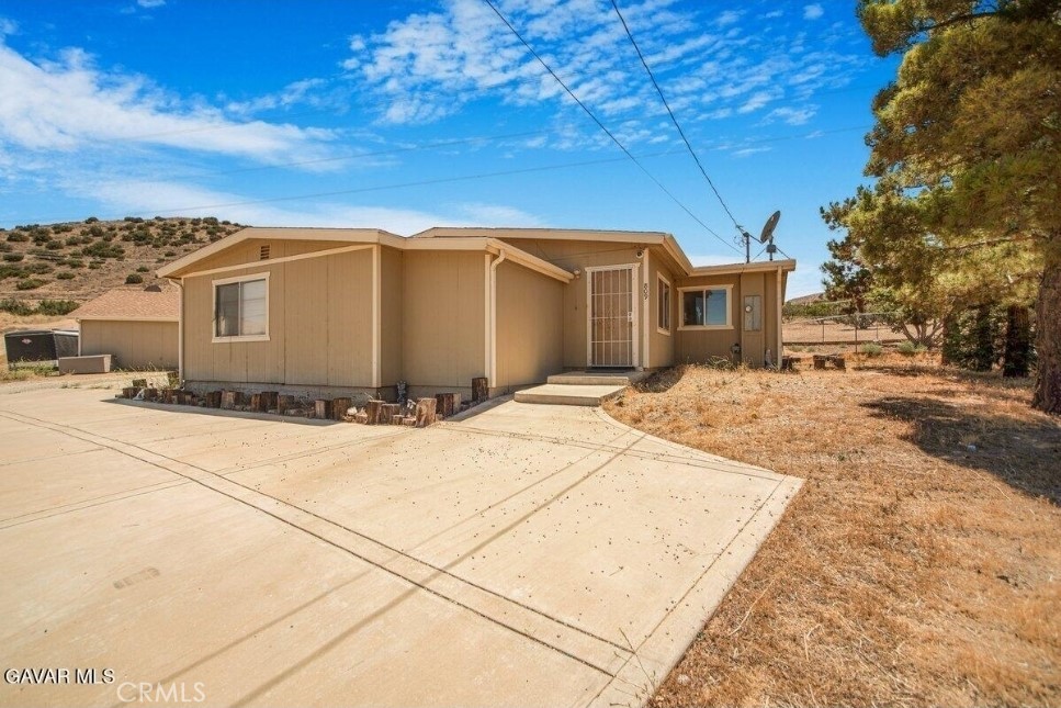 Opportunity Knocks In Scenic Acton! Take a look at this unique 3-bedroom, 2 bath plus a large bonus room home 1648 sg ft situated on a 30,492 sq ft lot With Its Own Well in Acton, California! The home offers endless potential in the heart of peaceful Acton, California-where panoramic mountain views and open skies meet small-town charm. Step inside to find a spacious living room featuring a freestanding wood-burning fireplace perfect for cozy evenings, that flows into a raised eat-in. The kitchen that has already been updated with modern countertops and backsplash, offering a great foundation to your dream culinary space. Enjoy the charm of a step-down primary bedroom with a walk-in closet, while one of the second bedrooms also boasts its own walk in. A bonus den provides the flexibility to create a second primary suite, office, or great room. There's also an indoor laundry for additional convivence. Out back, you'll find al detached garage-ideal for storage or, with the proper city approvals, a possible ADU conversion for added income or multigenerational living. One bathroom is currently mid-remodel, offering you the chance to complete it your personal taste. Don't miss your chance to own a slice of Acton tranquility with views that inspire peace and relaxation.