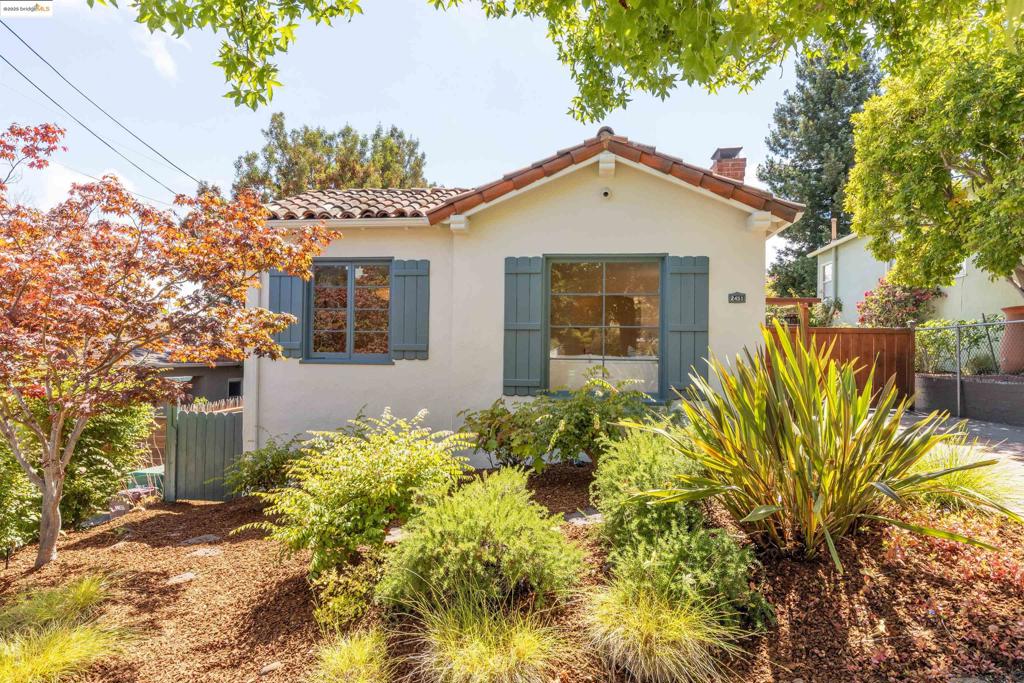 Welcome to this charming bungalow, located on a favored tree-lined street in Oakland. A colorful front garden coupled with a sparkling exterior creates a classic, sophisticated appeal. Step inside to find gleaming hardwood floors flowing throughout and bright communal spaces. The living room is centered around a fireplace while the large picture windows allow plenty of natural light in. Close by, the dining room features a modern light fixture and a striking accent wall, creating an inviting ambiance for gatherings. The adjoining eat-in kitchen boasts quartz counters, ample cabinetry, and stainless steel appliances with a sweet breakfast nook which allows for casual dining or a place to relax. Both bedrooms are located at the back of the home with views of the yard. Conveniently located, the stylish hall bath includes a shower over tub combination with colorful tile surround. Don't miss the bonus space measuring 328 sq ft - ideal for a home office or maker’s space - with washer/dryer nearby. The large, fenced-in backyard is ideal for weekend gardening & play: gorgeous grapevines and a large deck sets the stage for dining al fresco. A detached garage offers endless possibilities. Sewer compliant, numerous upgrades! Close to parks, trails, cafes, eateries and transport!