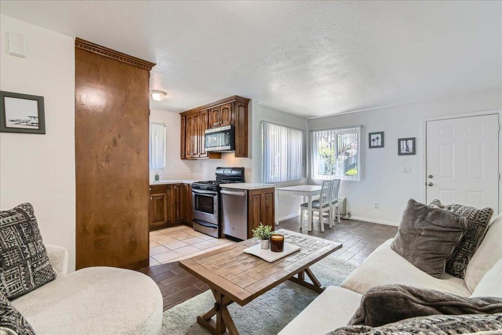 This turnkey and absolutely stunning gem, located in a secure gated community, is ready for you to call home! Unit is a short walk from your private parking spot with no steps. Clean, stylish, and move-in ready no renovations needed! Step into a bright and airy open floor plan that features an abundance of natural light and neutral colors throughout. The gorgeous, upgraded kitchen is equipped with sleek stainless steel appliances, perfect for any home chef. Elegant flooring runs throughout the unit, adding warmth and sophistication to every room. This single-story unit is conveniently located on the first floor and comes with private parking for your convenience.
