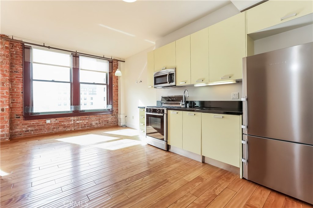 Live the best of DTLA life in this sleek loft on Spring Street in the iconic Rowan building. This loft was FEATURED IN CURBED LA!! Located in the Old Bank District in the booming Historic Core of Downtown LA, the Rowan was originally built in 1912 and exquisitely remodeled in 2008. Today's residents enjoy a beautiful mix of historic building features and high-end modern conveniences. Historic features include exposed brick walls, original large windows with beautiful mahogany frames, historic marble flooring in the lobby and restored exterior façade. The Rowan is a full amenity building, including a 24 hour doorman, resident's lounge, hot and cold plunge pools, outdoor BBQ area, dog run, secure parking, on-site dry cleaning valet and bike storage. All common areas are even WIFI-enabled. This cool loft has a wonderful open layout, 10-foot ceilings, exposed brick walls and top of the line appliances. The large windows let in luscious amounts of light. There's a nicely separated corner space for the bedroom area and a roomy bathroom plus laundry in the unit. Investment opportunity for anyone looking for built in income with a tenant currently renting, or live there yourself and enjoy being in the heart of the action! And best of all, take advantage of the Mills Act preservation property tax break! Also available for lease.