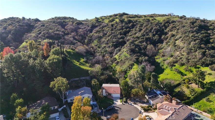 Tucked away at the end of a cul-de-sac in the hills of Tarzana this rental home offers privacy, space and comfort on an approximate 1.5 acre lot. This private and peaceful 4 bed/3 bath home offers 2,517 of stylish living space which is two stories with all bedrooms  located upstairs. Features include manufactured wood flooring, beautiful double wood entry doors, step down living room with a large fireplace and formal dining area. There is a large gourmet kitchen with gas range, built in refrigerator, granite countertops, walk in pantry, double ovens and tons of natural light. A very spacious family room with built in desk and shelving with lovely sliding glass doors out to a covered patio. Lushly landscaped in front and back with artificial turf, beautiful trees and shrubs offering beauty with low maintenance. There is a two car attached garage with laundry area.  This home has been freshly painted inside and out and has been perfectly maintained throughout the years.  Immediate occupancy!!!