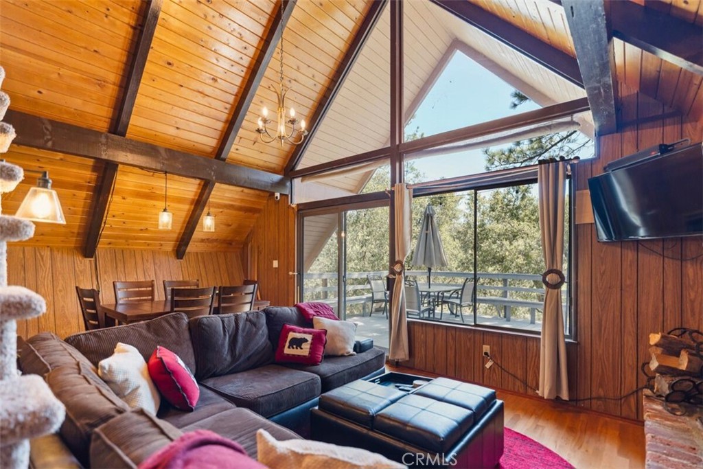 NEWLY PRICED, FULLY FURNISHED, DON'T MISS THE OPPORTUNITY!! Whimsical Mountain Chalet with Floor-to-Ceiling Forest Views and Dual Decks in a Private Cul-de-Sac! Escape to the serenity of mountain living in this charming 2-bedroom, 1.5-bath, 920 sq ft cabin nestled on a 10,733 sq ft lot that backs to a protected greenbelt forest. Tucked away on a peaceful cul-de-sac, this whimsical woodland retreat offers stunning floor-to-ceiling views, rustic elegance, and a true sense of privacy. Step into a bright and airy living space featuring soaring wood-beamed ceilings and expansive windows that bring the lush outdoors in. A cozy brick fireplace serves as the heart of the home during cooler months, while the open-concept kitchen provides the perfect setup for scenic cooking and effortless entertaining. The living and dining areas open out to two oversized decks—east and west facing—each with built-in seating, ideal for morning coffee, evening BBQs, or stargazing under clear mountain skies. The main level features a spacious guest bedroom, full bathroom, large pantry, and generous storage. Upstairs, the inviting primary suite boasts treetop views, beautiful natural light, and its own private half bath. Sold fully furnished and newly priced, this cabin is move-in ready—just bring your bags and settle into mountain life. Whether you're seeking a full-time home, creative hideaway, or weekend escape, this distinctive retreat checks all the boxes. Just minutes from Pine Mountain Club village amenities—yet worlds away from the rush. Schedule your private tour today!