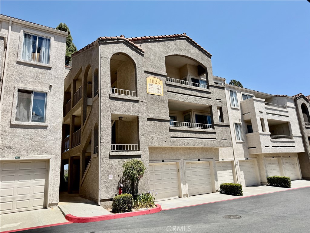 Meticulously updated 1-bedroom, 1-bathroom condominium located in the highly desirable Triana Gated community of Corona Hills. Encompassing 724 square feet, this spacious residence offers the largest one-bedroom floor plan in the neighborhood, showcasing an open-concept design, upgraded baseboards, crown molding, and granite countertops in the kitchen. The generously sized bedroom features a private balcony ideal for unwinding, also comes with a storage room on the balcony, while the modernized bathroom and in-unit washer and dryer provide added comfort and convenience. A private covered carport with storage cabinet and ample guest parking are included within this secure, gated community. Residents enjoy access to an array of premium HOA amenities, including a fitness center, clubhouse, swimming pool, two spa areas, and beautifully maintained landscaping. Monthly HOA dues cover water, sewer, and trash services, adding to the property's value. Ideally situated near Costco, Walmart, local dining, parks, and the Corona Metro Station—with easy access to the 91 and 15 freeways—this move-in-ready home, built in 1991 and exceptionally maintained, offers a perfect blend of comfort, style, and convenience.