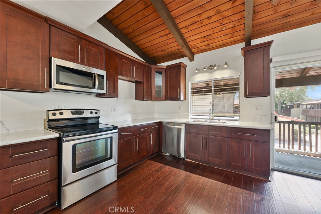 UPSTAIRS UNIT IN THE GATED COMMUNITY OF MACARTHUR VILLAGE! Enter the main level to the open floor plan. Wood flooring in the living and dining area and bedrooms. The kitchen is updated, stainless steel sink, stainless steel appliances, built-in microwave and a nice window looking out from the sink area, that opens to let natural light and air through. There is an outdoor balcony space. There are 2 bedrooms and 2 full baths. The bathrooms are upgraded as well. Includes one assigned carport space (#126). The community offers amenities including a pool, tennis courts, gym, clubhouse, BBQ areas and community laundry. Conveniently located near South Coast Plaza, with many shops, restaurants, entertainment, and more. Easy access to the 55 and 405 freeways and toll roads.