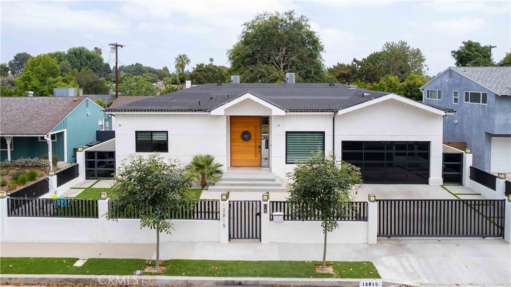 Set on a quiet residential street in prime Valley Village, this newer construction home blends modern design with everyday comfort. Completed in 2022, the 3-bedroom, 3-bath residence offers nearly 2,900 square feet of open living space with thoughtful finishes throughout. The main living area features marble floors and seamless indoor-outdoor flow, with sliding doors that lead to a covered patio, built-in BBQ, and a private pool—ideal for entertaining or relaxing year-round. The kitchen is both stylish and functional, equipped with granite countertops, Miele appliances, a built-in coffee maker, and an oversized island. Two bedrooms include ensuite baths, offering privacy and flexibility for guests or home office use. Additional highlights include large walk-in closets, a hidden refrigerator, an intercom system, and a layout that suits a modern lifestyle. Located moments from top-rated schools, dining, and shopping, this move-in-ready home pairs contemporary convenience with timeless appeal in one of the Valley’s most sought-after neighborhoods.