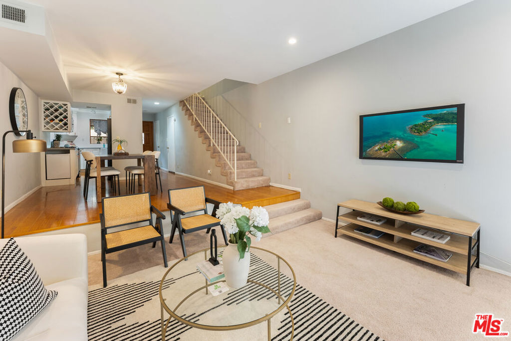 Located in the vibrant NoHo Arts District, this stylish three-bedroom, two-and-a-half-bathroom townhome blends modern updates with comfortable living spaces. The updated kitchen boasts white shaker cabinetry, quartz countertops, and stainless steel appliances, opening to a spacious dining area. A step-down living room with a cozy fireplace and direct patio access creates the perfect spot for entertaining or relaxing. Upstairs, the private primary suite sits at the back of the home, offering peace and quiet, ample closet space, and an en-suite bathroom. A second generously sized bedroom, a full bathroom, and a convenient laundry nook with a stackable washer and dryer complete this level. On the third floor, the additional bonus room provides endless possibilities, whether as a third bedroom, home office, creative studio, or den. From here, step out to your private rooftop deck and enjoy sunny afternoons or dining al fresco under the stars. This townhome is in a small complex with only 6 other units, and includes two tandem parking spots in a gated garage. It offers the best of city living with easy freeway and public transportation access, plus unbeatable walkability to trendy shops, restaurants, and everything the NoHo Arts District has to offer.