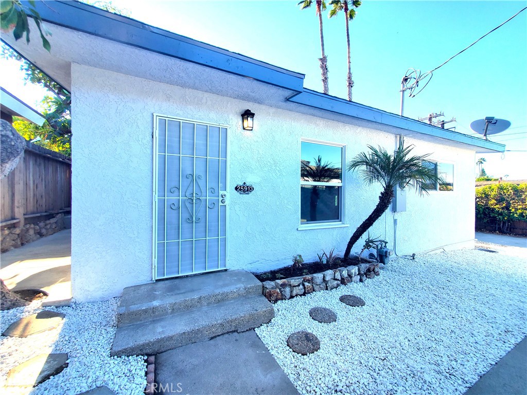 This charming 2-bedroom, 1-bathroom detached back house of a duplex has been fully renovated. Both the interior and exterior have been freshly painted. This home boasts new windows, newer laminate flooring throughout with a spacious living room, and a newly renovated bathroom. The kitchen features white cabinets with new quartz countertops, new range hood, new gas range, new faucet, new quartz sink, and new garbage disposal. The laundry hookup is situated in the kitchen for convenience. This home has a spacious private backyard and a long driveway with an extra long carport. Situated in a sought-after quiet neighborhood of Lomita in a cul-de-sac, this residence offers convenient walking access to Rolling Hills Plaza, AMC theaters, various shops, and restaurants, and is only a short drive from the 110 freeway and the beach.