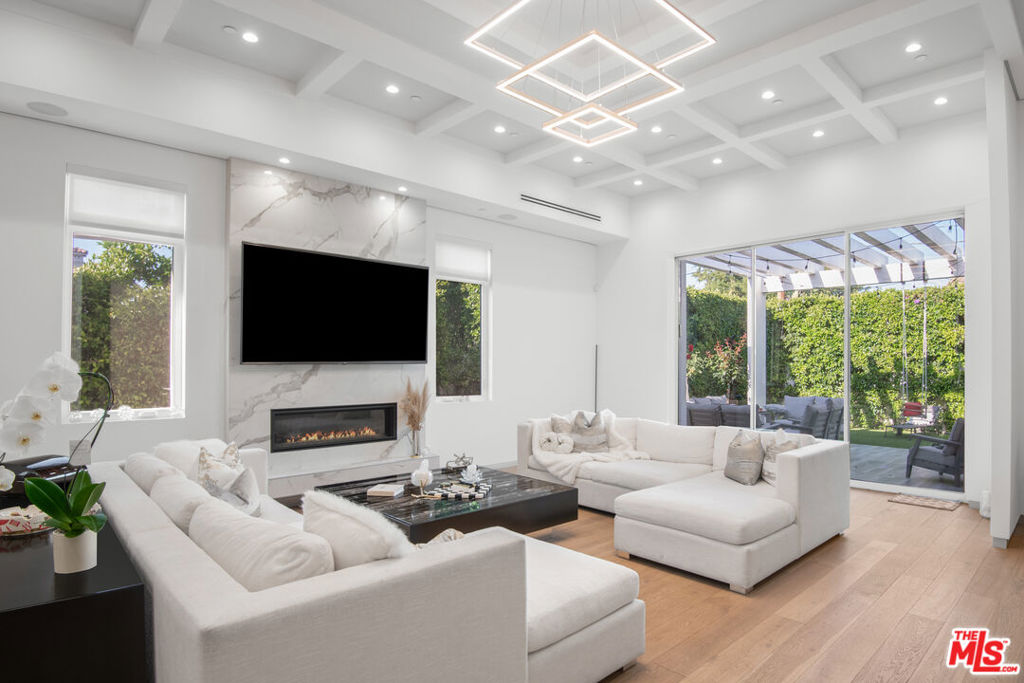 This stunning modern masterpiece in Sherman Oaks presents the perfect fusion of style and functionality. Completely reimagined in 2018, the home features soaring ceilings and a generous single-level open floor plan that flows seamlessly between living spaces, creating an ambiance of elegance and ease. The large kitchen complete with a pantry, spacious island, and abundant storage is a culinary enthusiast's dream, with meals easily enjoyed in the expansive dining area, ideal for entertaining family and friends. The impressive primary suite is a true sanctuary, showcasing a custom-built closet and a spa-like bathroom with a soaking tub and oversized shower. Each spacious secondary bedroom includes its own en-suite bathroom, offering both privacy and convenience. Outside, the cozy backyard, nestled among mature hedges, provides a tranquil setting of seclusion and charm. Additional features include a security system, motorized gate, and built-in speakers throughout. Perfectly positioned on a serene tree-lined street just north of Ventura Boulevard, this home offers a peaceful retreat while keeping you close to shops, dining, and all the best of Sherman Oaks living. Home may be sold furnished or partially furnished.