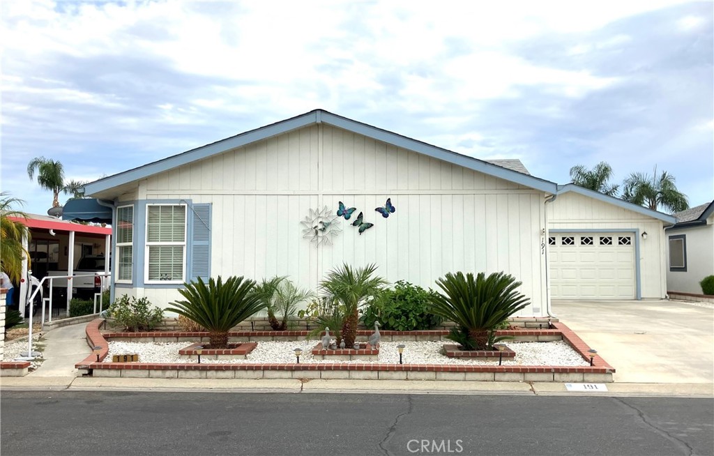 WELCOME HOME SENIORS.....THE FOOTHILLS OF HEMET....This is seriously one of the nicest parks in the Hemet/San Jacinto area....Here we are presenting a 3 bedroom (one is more of a dedicated office space with built ins) and 2 full bathrooms....This home is almost 1700 sq ft so there is plenty of room and you also have a 2 car garage with even more storage....The main living area has new LVP flooring so very easy to care for and the rest of the home is carpet....The kitchen in this house is an entertainer's delight.... tons of storage and an island in the middle for all your food prep needs...There is a formal living room and a less formal living area with a gorgeous fireplace and built ins...There is a dedicated laundry room with even more storage....The driveway is also pretty awesome...lots of room for probably 4 more vehicles...The park itself is pretty wonderful...Gated 24/7 for your peace of mind...There are tons of activities if your interested...There is a huge clubhouse where the park holds all of its gatherings and dinners and BINGO on Friday nights...TWO swimming pools, a pickelball court, a gym, a library, crafts room, tv room, pool tables and card tables...last but certainly not least is Shuffleboard....these folks are serious players so come join our fun here !!!!