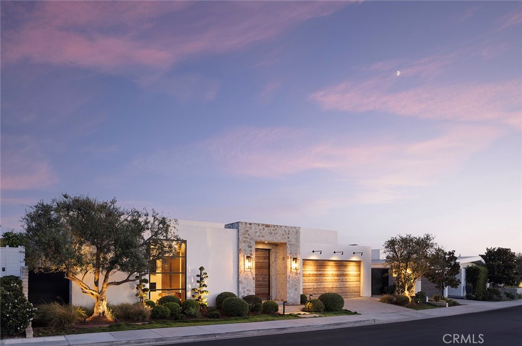 Sitting on a bluff and framed by sweeping views and of Newport Harbor, the Pacific Ocean, and golden evening sunsets, 624 Ramona captures the spirit of refined coastal living in Corona del Mar’s coveted Irvine Terrace. Every space of this single-level contemporary masterpiece is curated with intention—bathed in natural light, layered in texture, and designed for effortless indoor-outdoor flow.  The private entry opens to a stunning great room where floor-to-ceiling glass doors dissolve the boundary between inside and out. An open kitchen anchors the space with waterfall-edge counters, professional appliances, and a wet bar—setting the stage for everything from intimate dinners to lively gatherings under the stars. The primary suite is a sanctuary of calm, with a fireplace, retractable glass doors framing ocean views, and a spa-worthy bath that spills out to a private garden patio. Two fully appointed en-suite bedrooms, a media room, an office with room for guests (or optional fourth bedroom), and a dedicated massage room with infrared lighting offer both versatility and luxury. Every finish, fixture, and design element reflects the highest level of craftsmanship—resulting in a home that feels as effortless as it is elegant. Perfectly positioned moments from local yacht clubs, Newport Beach Country Club, Balboa Island, and all of the best shopping and restaurants, this residence defines the art of coastal California living.