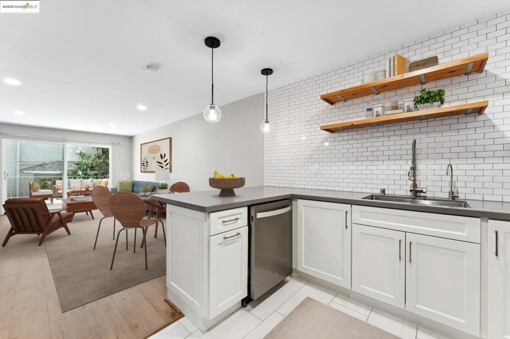 Just steps from Lake Merritt in vibrant Adams Point, 424 Staten #104 is your stylish city retreat. This updated 1BR/1BA condo shines with a renovated kitchen, bath, floors, and lighting, giving it a fresh, modern edge. The open kitchen, dining, and living space is perfect for hosting friends or keeping it low-key, with plenty of storage and sleek finishes. Slide open the door to your expansive private balcony—ideal for coffee runs from your favorite café, sunset happy hours, or weekend brunch in the sun. Amenities include secure building access, gated garage parking, extra storage, bike racks, and a community laundry room. With a 97 Walk Score, you’re steps from the farmers’ market, Grand Lake Theater, buzzing restaurants, boutiques, and the trails around Lake Merritt. Easy freeway and transit access make commuting a breeze. Move in, plug into the neighborhood, and make the most of Oakland living. Furnishings are computer-generated; buyer to verify accuracy/scale.