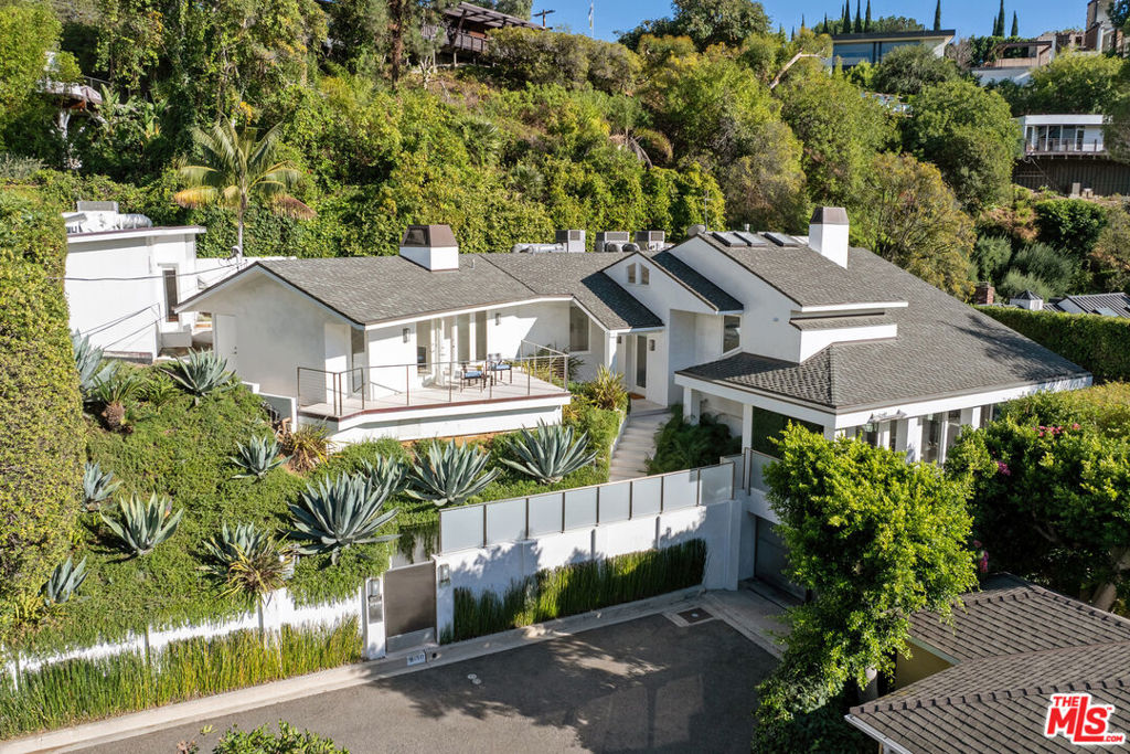Beautiful furnished contemporary architectural jewel tucked away at the end of a cul-de-sac street in lower Doheny Bird Streets. Elevated from the street and behind stainless steel gates. Sun filled open spaces with walls of glass opening to patios and overlooking sparkling pool, spa and waterfall. Loft style living room with hardwood floors, gourmet kitchen, family room with fireplace, spacious bedrooms, elevator and a separate guest house/studio w/ bath. Long term tenants preferred. Some art and rugs are virtually staged and will not be included in the furnished rental.