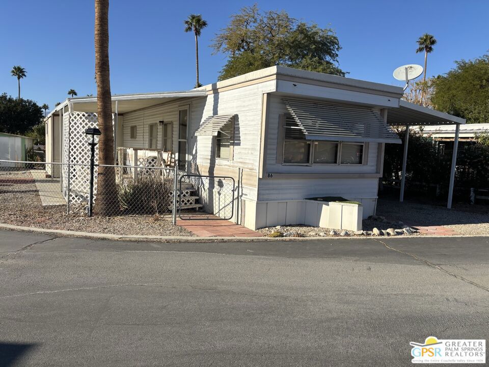 Welcome to the peace and tranquility of desert living in Wagner Mobile Home Park, a 55+ senior community with hot and cold mineral pools. This furnished 2 bedroom, 1 bath home is located on a corner lot with a fenced yard complete with flowering plants and a citrus tree, and a patio with spectacular mountain views. There is an additional room that can be used as a third bedroom, office, or family room; the possibilities are endless. A kitchen eating area, breakfast bar, outdoor storage shed, and attached carport with plenty of parking, complete this charmer. Conveniently steps away from the community clubhouse, pools and spas. With a little TLC you can make this your own! Don't miss checking this one out!