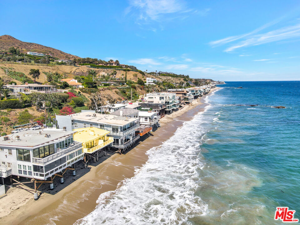 This is a rare opportunity to purchase a "fixer-upper" with 50 feet of frontage on Beautiful Malibu Road. Off the Highway and located among the most desirable beach homes in Malibu . Originally built in 1957 with side by side one bedroom units on the first floor and a third unit was on top of the 4 car garage. Several years ago the unit above the garage was destroyed by a house fire. The building has been a rental for the past 15 years to a single tenant. Now Vacant, and easy to show the owner is motivated and finished with the cosmetic restoration & repair. Please call listing agent for more information of this great investment opportunity.