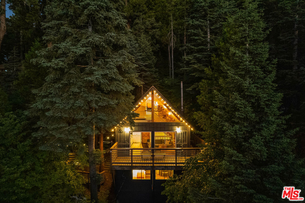 Find your quiet: big lake views, deep privacy, and hiking trails just steps from your door. Secluded glass-walled A-frame with dramatic lake + sunset views from all 3 levels. Sits on six parcels (~0.338 ac per public record) offering rare privacy. Title shows 2BD/1.5BA; lives like 3BD/1.5BA with lower-level Master Suite (buyer to verify). Detached structure (~80sf, buyer to verify) with lake-view windows. Vermont Castings woodstove, GAF roof (2018) w transferrable 50 year warranty, newer heater + ducting (2020.). Outdoor spa patio, multiple decks, stone patios and landings. The lot abuts a former 1950s homesite -included with the sale- with remaining foundation, stairs, and utilities at the street (ADU potential; buyer to verify feasibility). Surrounded by seasonal dogwoods that bloom in spring; lake fireworks visible in summer. Located in Arrowhead Woods but no HOA and no lake rights. Road is not county maintained. Title shows 2 bedrooms. Listing agent has ownership interest.