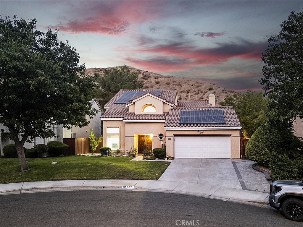 Welcome to 30030 Grandifloras Rd, Canyon Country! Nestled at the end of a peaceful cul-de-sac in the quiet and beautiful neighborhood, this stunning 3-bedroom, 3-full bathroom home has been thoughtfully remodeled in 2019 with modern updates throughout, Step inside to soaring vaulted ceilings with open, bright living space that feels both spacious and inviting. The remodeled kitchen features quartz countertops, elegant cabinetry, and flows seamlessly into a formal dining and family room with a fancy fireplace. Beautifully engineered wood flooring runs throughout the home, adding warmth and charms. Upstairs, the large master suite offers a luxurious en-suite bathroom with separate tub and glass doors shower. Two additional bedrooms share a convenient Jack and Jill bathroom. Downstairs, a private office can easily be converted into a 4th bedroom, complemented by a full bathroom. Enjoy your own private retreat in the backyard with a sparkling updated pool, perfect for relaxing or entertaining. Additional highlights include water softener for the entire house, security cameras for peace of mind and a charming backyard oasis. This home truly combines elegance, comfort, functionality- ready for you to move in and enjoy.