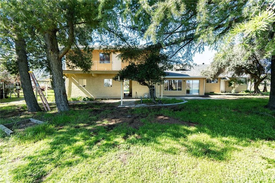 2 Homes tucked away on nearly 28 acres of Orchards, a Shop, Owned Solar & a 10 hp inverter pump in the Ag well which serves the homes as well.  The pump was recently replaced at approx174ft seller was told water static level was 50 ft.  Currently this property  has approx 10 ac of Manzanilla Olives and 15 ac Prunes partially irrigated by micro sprinklers & partially by the Orland Irrig Dist. The sizable shop has an office area and 220 wiring.  All of this works together to present an amazing opportunity. If you don't farm trees, there are plenty of uses for this beautiful piece of ground. The main house is spacious, 2,750 sq.ft. retreat, executes warmth & modern features along with some craftsman charm.  There are amazing 360 views from it's upstairs Primary suite & balcony. Step inside to find stunning hickory wood flooring, expansive living spaces, and a gorgeous brick fireplace with an intricate tile mosaic, creating the perfect setting for cozy evenings. The large kitchen is a true centerpiece, featuring a walnut-topped island with a built-in electric cooktop, ample cabinetry, a built-in oven and microwave, & a charming dining area warmed by an ornate wood stove. Whether hosting guests or preparing meals for your own farm-fresh harvest, this space is designed for gathering. The home boasts 4 generously sized bedrooms, including two primary suites offering flexibility for multi-generational living. Primary Bedrooms is above the carport/garage with a full bath, walk-in closets and a balcony. There is also a basement, perfect for extra storage or a wine cellar. Outside find a sizeable yard with covered a patio and plenty of shade. Thoughtfully designed for both comfort and function, the main home and Ag/Dom well are powered by a 44-panel owned solar system, significantly reducing energy costs for home & irrigation. A short distance away, the approx. 800 sq. ft.1 bedroom guest house is perfect for extended family, rental income, or a private retreat. Recently updated, it provides a cozy yet modern living space. A 30+ac  fruit tree family orchard adds to the bounty with Grapes, Apricots, Pears, Pomegranates, Black Walnuts, Oranges, and Pecans. Shop was rented  & now stands ready for new opportunities with its separate electrical service. A loop driveway makes daily life convenient, whether you're managing the farm or have large trucks,  Sq Ft, lot size & year built are from county records, buyer to verify this and all information to their satisfaction.
