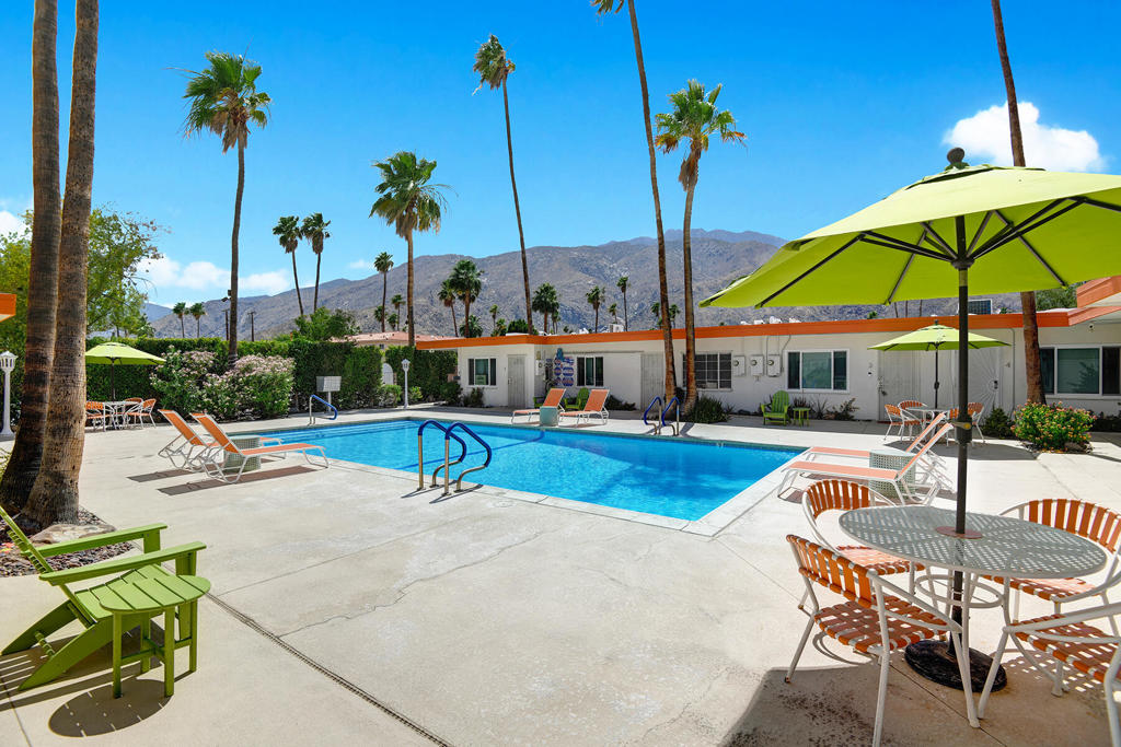 Welcome to Lantana Lodge, a hidden mid-century gem in the heart of Palm Springs' historic Movie Colony neighborhood. Built in 1947, this charming Studio, 1-bath condo is part of a storied property once favored as a discreet desert retreat for Hollywood's elite. Today, it offers the perfect blend of classic charm and modern comfort.The unit has been thoughtfully updated throughout. Recent improvements include energy-efficient windows, a custom full glass front door with built-in blinds, and a stylish sunburst metal security door--all secured with Schlage keyless entry locks. A Ring security system with hardwired video doorbell, motion detection, and sensors provides added peace of mind.Inside, you'll find new flooring throughout with built-in antimicrobial protection. The bathroom has been refreshed with a new vanity, toilet, professionally reglazed tub and shower, and a new glass shower door. The kitchen features a Haier gas stove along with a new refrigerator and microwave. A newer HVAC mini-split system (installed in 2023) ensures year-round comfort.A spacious walk-in closet offers potential for in-unit laundry hookups, although residents can also take advantage of the free on-site laundry, included in the HOA. The private rear patio is ideal for relaxing or entertaining, with mountain views, a lemon tree with irrigation, and a storage shed.This fully furnished, turnkey unit is just a short distance to Palm Springs favorites like Sandfish Sushi, Trixie Motel, the Arrive Hotel, Heyday, Kartel Coffee, and more. It's also less than 10 minutes to the Tramway and an easy bike ride to downtown via the nearby city loop trail.The HOA covers all utilities--electricity, gas, water, trash, landscaping, pool, and laundry--making ownership simple and affordable. With a newer roof and a location steeped in local history, this is a rare opportunity to own a stylish piece of Palm Springs at Lantana Lodge.