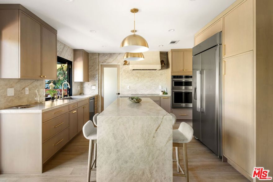 Tucked away on a quiet cul-de-sac in the desirable Fountainwood neighborhood of Agoura Hills, this beautifully renovated home offers rare privacy, premium finishes, and modern functionality and is available for rent for the very first time. Offering approximately 2,350 SF of superiorly updated living space on an expansive 11,000 SF lot, the home features extensive upgrades throughout. A private courtyard entry opens to a light-filled foyer with high ceilings and recessed lighting. The spacious living and dining rooms flow effortlessly into the fully updated kitchen, showcasing Merit cabinetry, Taj Mahal quartzite countertops, Thermador induction cooktop, and other premium appliances. The kitchen overlooks the inviting family room, highlighted by a limestone plaster fireplace for relaxed gatherings.  The office on the main level includes custom built-ins and a dry bar with wine fridge - perfect for working or entertaining in style. Upstairs, the primary suite enjoys serene treetop views, a private deck, and a refreshed bath with dual vanities, while the secondary bedrooms share a fully updated bathroom. Outside, the expansive backyard offers established lawn, mature trees, and multiple patios backing to open space offering ultimate privacy - ideal for entertaining or quiet relaxation. The yard is also a gardener's delight, with various fruit trees including lemon, lime, grapefruit, clementine, apple, and more. A saltwater hot tub (maintained by the landlord) completes the outdoor retreat, providing the perfect setting for year-round enjoyment. Designed for modern sustainability, the home features landlord-provided solar panels and a whole-home backup battery system that substantially reduce monthly energy costs and reliance on the utility grid. A Level 2, 240V electric vehicle charger offers additional convenience for EV owners. Set within one of Agoura Hills' most sought-after neighborhoods, this home combines privacy, modern comfort, and proximity to top-rated schools such as Willow Elementary, Mariposa, and Sumac Elementary (all schools of choice), as well as local parks and scenic hiking trails.