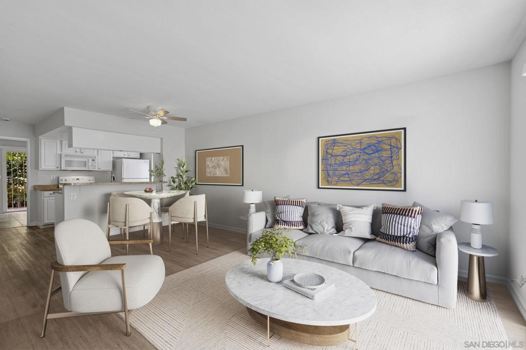 Nestled on a quiet corner in a welcoming community, this bright and airy corner unit townhome feels like the perfect beginning to your next chapter. Step inside to find a sunlit living room that opens effortlessly to a dedicated dining area and kitchen—ideal for family dinners, casual gatherings, or morning coffee rituals. Newly installed laminate flooring adds warmth and continuity throughout the main living space, kitchen, and upstairs bedrooms. The galley-style kitchen is the heart of the home, with crisp white cabinetry offering ample storage and a clever layout that keeps you connected to the rest of the space. Whether you're whipping up weeknight dinners or hosting Sunday brunch, you'll love how the kitchen overlooks the living room, making it easy to entertain or keep an eye on things. Downstairs, a versatile bedroom with sliding doors to the large outdoor patio offers flexibility—use it as a guest suite, a home office, or a playroom for little ones. A convenient downstairs powder room adds to the functionality. Upstairs, discover two spacious bedrooms with generous closets and two well-appointed bathrooms, providing comfort and privacy for everyone. Outside, your private patio becomes a peaceful escape, surrounded by mature trees and leafy greenery—a rare find that offers both shade and serenity. With one assigned garage space, an additional assigned parking spot, and access to community laundry with new Speed Queen washers and dryers, everyday convenience is built right in. The HOA recently upgraded the plumbing and roofing to improve your living experience. Located conveniently near North Park, Kensington, and Normal Heights, this charming neighborhood really feels like a Walker's Paradise. You'll enjoy exploring the variety of nearby restaurants, shops, and schools that add to its appeal. Just 2.5 miles from SDSU and minutes from schools like Franklin Elementary and Hoover High.