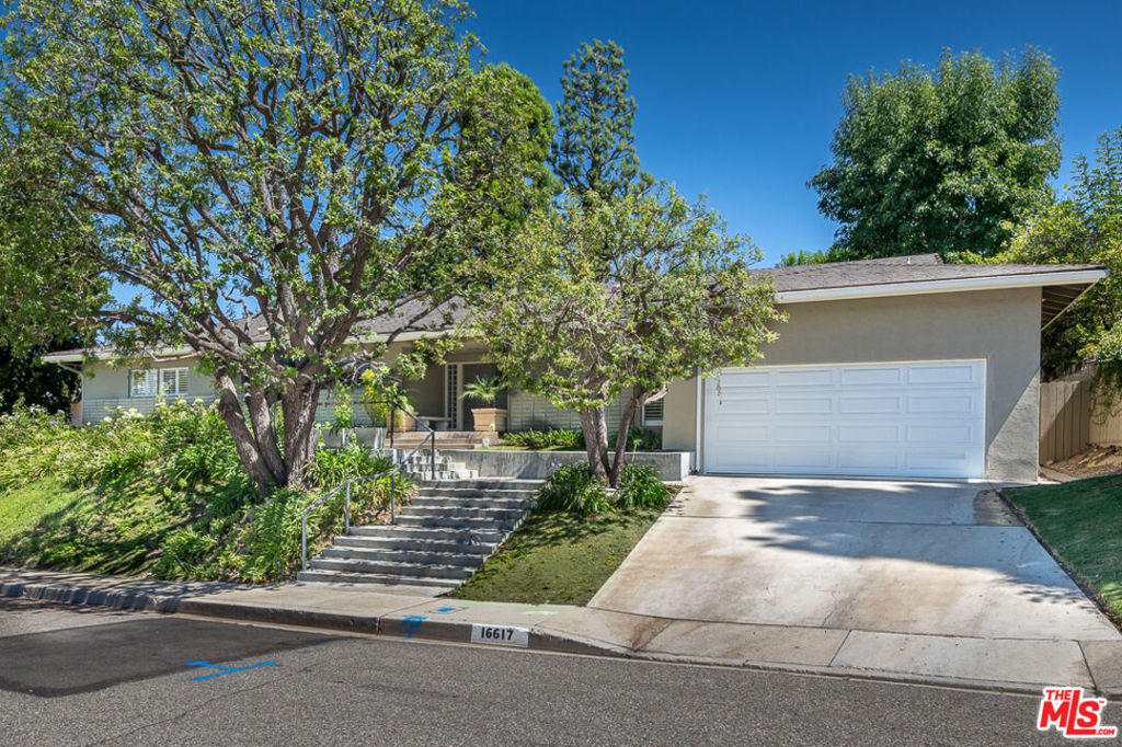 Surrounding a serene backyard retreat with a black-bottom pool, brick decking, fountain, and multiple lounging areas, this single-story contemporary delivers both style and comfort in the heart of upper Brentwood's coveted Bel Air Knolls. Spanning approximately 3,386 sq ft on an expansive 11,931 sq ft lot, the home offers 5 bedrooms, 4 bathrooms, and a thoughtful layout designed for everyday living and entertaining. Inside, clean architectural lines, stone-tiled floors, and walls of windows fill the interiors with natural light creating a warm yet refined ambiance throughout. The formal living room features a granite wet bar, fireplace, custom entertainment center, and sliding doors to the outdoors, while the elegant dining room opens to a pergola-covered patio ideal for gatherings. A chef's kitchen appointed with granite countertops, stainless steel appliances, and maple cabinetry connects to a spacious family room with built-ins and patio access. The private primary suite serves as a calming retreat with direct access to the pool, plantation shutters, and an ensuite bath. Additional bedrooms are generously sized, including a private guest suite near the kitchen. A dedicated laundry area links to the attached two-car garage. With convenient proximity to the 405 and 101 Freeways, Mulholland Drive, the Getty, and top-rated schools including Roscomare, Curtis, Berkeley Hall, Milken, Mirman, and UCLA, this timeless property offers exceptional livability in one of Los Angeles' most desirable neighborhoods.
