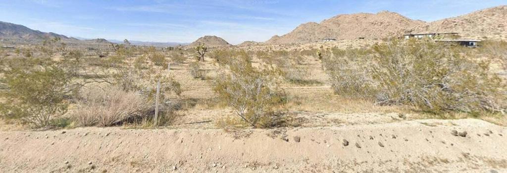 Located in Monument Manor, one of the most coveted areas of Joshua Tree as it is approximately 1.5 miles from the west entrance of Joshua Tree National Park.Water and electric available at the street.Seller has planes for a 3bedroom 1 bath included in sale price. Property has areal survey. Buyer to verify if this lot is able to be subdivided into 2, 2.5 acre lots with the county. A survey has also been done and the corners have been marked. Seller has 2 drawings paid for and will include in the sale as part of negotiations.PLEASE DO NOT access North side of the lot through Sacred Sands property. access Lobo Pass Rd on LEFT SIDE ONLY north of Quail Springs Rd.