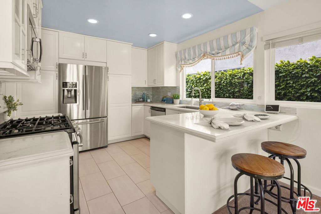 Welcome to this warm and inviting 3-bedroom, 2-bathroom (PLUS den/office), retreat tucked away on a quiet cul-de-sac street, a hidden gem within the Del Rey neighborhood.  As you step inside the double-door entrance, you're greeted by a spacious formal living room, perfect for relaxing or entertaining. The adjacent dining room/den/office leads to a remodeled kitchen featuring quartz countertops, abundant storage, stainless-steel appliances, and breakfast bar. The kitchen flows into a cozy living area with fireplace and a sliding glass door leading to the covered back patio and landscaped yard. The primary suite, with a double-door entry, offers a tranquil escape, featuring a recently remodeled ensuite bathroom and two large walk-in closets with mirrored doors. Continuing down the hallway, you'll find plentiful cabinets and another storage closet. Two additional spacious bedrooms include large closets with mirrored doors and large windows overlooking the lush backyard landscaping. Dual-pane windows throughout the home ensure peace and quiet.  The backyard provides space for dining, entertaining, and enjoying the California sunshine, while the front yard is beautifully landscaped with rich greenery and a large lemon tree. Additional perks include large two-car garage with EV charger, a gated entryway, as well as a security camera system for added peace of mind, newer HVAC system and a washer/dryer area in the garage.  Located near Playa Vista, Marina del Rey, and Culver City, this home offers easy access to Ballona creek bike path, beaches, and LAX. Available for immediate occupancy.