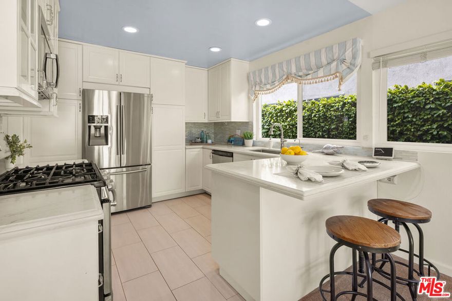 Welcome to this warm and inviting 3-bedroom, 2-bathroom (PLUS den/office), retreat tucked away on a quiet cul-de-sac street, a hidden gem within the Del Rey neighborhood.  As you step inside the double-door entrance, you're greeted by a spacious formal living room, perfect for relaxing or entertaining. The adjacent dining room/den/office leads to a remodeled kitchen featuring quartz countertops, abundant storage, stainless-steel appliances, and breakfast bar. The kitchen flows into a cozy living area with fireplace and a sliding glass door leading to the covered back patio and landscaped yard. The primary suite, with a double-door entry, offers a tranquil escape, featuring a recently remodeled ensuite bathroom and two large walk-in closets with mirrored doors. Continuing down the hallway, you'll find plentiful cabinets and another storage closet. Two additional spacious bedrooms include large closets with mirrored doors and large windows overlooking the lush backyard landscaping. Dual-pane windows throughout the home ensure peace and quiet.  The backyard provides space for dining, entertaining, and enjoying the California sunshine, while the front yard is beautifully landscaped with rich greenery and a large lemon tree. Additional perks include large two-car garage with EV charger, a gated entryway, as well as a security camera system for added peace of mind, newer HVAC system and a washer/dryer area in the garage.  Located near Playa Vista, Marina del Rey, and Culver City, this home offers easy access to Ballona creek bike path, beaches, and LAX. Available for immediate occupancy.