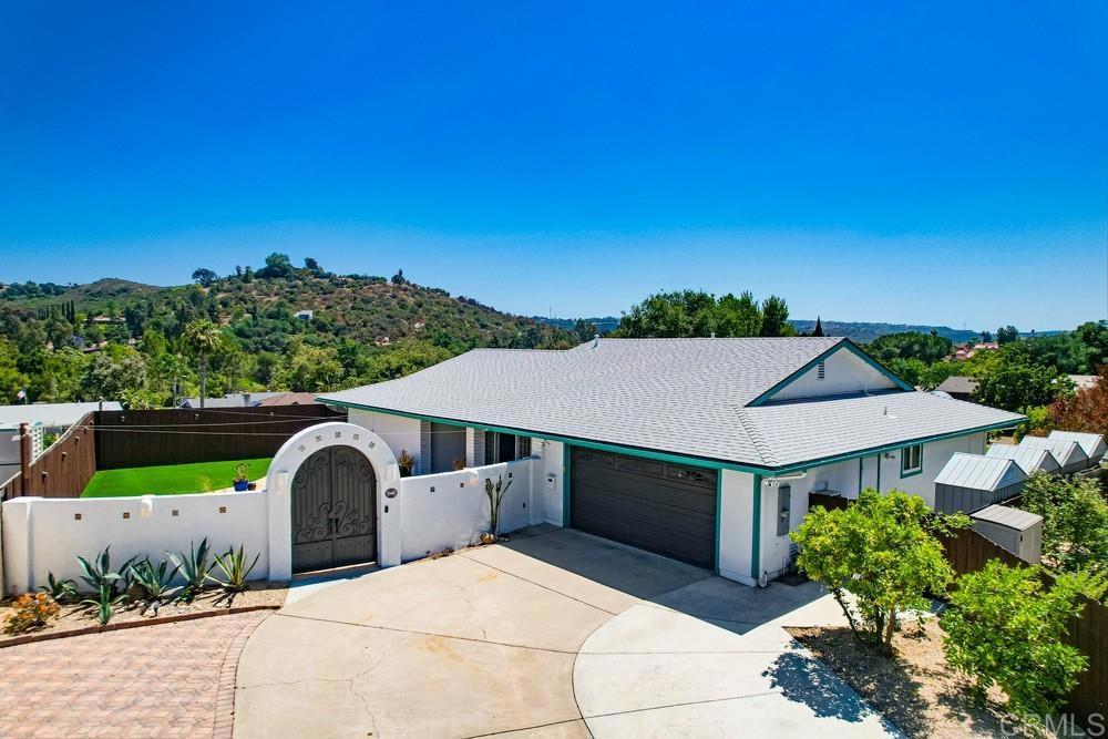 Tucked at the end of a quiet cul-de-sac in the highly desirable "Poway Portals" neighborhood, this single-story retreat blends everyday comfort with long-term versatility. Quick Freeway access– only 13 miles to the beach at Torrey Pines and only 21 miles to the airport and downtown San Diego. Set on a flat, fully usable 15,000 sq ft lot (? acre), this 1,913 sq ft home (including a 384 sq ft sunroom) delivers the feel of a secluded hideaway with a relaxed Baja coastal vibe. The layout offers ideal separation of space for multigenerational living, potential income through an ADU, or simply room to grow and live your way.Step through stunning 9-ft iron double doors into a sunlit flagstone courtyard, where children can safely play, friends can gather, or you can relax beneath the stars. Inside, an open floor plan balances privacy and connection, with the primary suite tucked away from secondary bedrooms for a flexible, family-friendly feel. Wake up with sunrises on the east-facing front porch, and wind down with sweeping sunset views over Twin Peaks from the tranquil backyard. Mature trees, elevation from neighboring homes, and strategic landscaping create an exceptional sense of seclusion rarely found in suburban settings—perfect whether you're enjoying the backyard sauna, hosting a barbecue, or harvesting fruit from your own garden. The updated kitchen features quartz counters, a deep basin sink, and a spacious walk-in pantry, flowing seamlessly into the living and dining areas. A wood-burning fireplace with a custom live-edge Parota wood mantle warms the living room, while a built-in bar area—complete with wine storage, beverage fridge, and dual sinks—makes entertaining effortless. The sunroom adds 384 sq ft of flexible space for a gym, office, studio, playroom, or bonus dining area—bringing the outdoors in with natural light and peaceful views. See Supplement for More Info New 30-year Energy Star roof (2019) New HVAC system (2020) Solar-ready 200A electrical panel Dual-pane windows & whole-house attic fan Durable tile and laminate flooring with upgraded baseboards and casing throughout With a 75+ ft driveway (~2,300 sq ft of hardscape), there’s ample room to park an RV, boat, and multiple vehicles. The fully finished garage adds even more function, featuring built-in cabinetry, recessed speakers, detailing fans and lights, attic storage, and wall-mounted AC—ideal for a workshop, gym, creative space, vehicle enthusiast, or future conversion to a guest suite or ADU. Out back, there’s room to dream: add a pool or a sport court to the already expansive garden. The irrigated, low-maintenance yard features a Finnish 4-person electric sauna and a mini orchard of mature fruit trees, including citrus, stone fruit, figs, apples, pears, and mulberries. Zoned RS-7 with side access, the lot supports future ADU potential, backyard chickens, or 4-H/FFA projects. Six discreet 6x6 storage sheds, a Ring security system, and included extras like a wall-mounted TV and garage cabinetry round out the package. Just steps from local trailheads and part of the award-winning Poway Unified School District, this home offers a rare blend of nature, comfort, and future value—with no HOA or Mello Roos to limit your vision. Whether you’re growing your family, seeking a peaceful retreat, or adding to your portfolio, 12919 Evalyn Place is ready to grow with you.