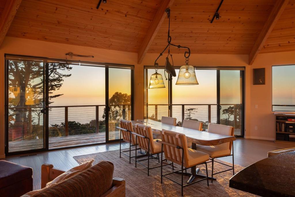"Misty House", long celebrated as an artist's haven, is defined as much by its unique history as it is by its panoramic white water views. It was once the home of Johnny Adams, a local disc jockey whose deep connection to the world of jazz music ultimately inspired Clint Eastwood's first directorial project, Play Misty for Me. Perched on a Carmel Highlands hilltop overlooking the Pacific, this mid-century modern residence is an architectural marvel. In 2016, Studio Carver Architects remodeled it down to the studs, creating an inviting open layout with grand 16ft ceilings and floor-to-ceiling windows throughout. The main level features two bedrooms and two bathrooms, with the kitchen and great room connecting to a wrap-around deck high above the bay showcasing incredible views to Point Lobos and south toward Big Sur. The lower level has a separate entrance, making it a perfect third bedroom for guests, a home office, or a studio complete with a darkroom for traditional photography. The property boasts excellent infrastructure, including owned solar, air conditioning, and a robust driveway built to withstand the elements of Highlands living. This is truly a slice of Big Sur with the convenience of Carmel just 10 minutes to town.