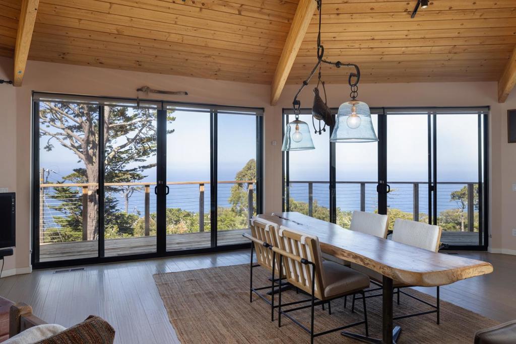 "Misty House", long celebrated as an artist's haven, is defined as much by its unique history as it is by its panoramic white water views. It was once the home of Johnny Adams, a local disc jockey whose deep connection to the world of jazz music ultimately inspired Clint Eastwood's first directorial project, Play Misty for Me. Perched on a Carmel Highlands hilltop overlooking the Pacific, this mid-century modern residence is an architectural marvel. In 2016, Studio Carver Architects remodeled it down to the studs, creating an inviting open layout with floor-to-ceiling windows throughout. The main level features two bedrooms and two bathrooms, with the kitchen and great room connecting to a wrap-around deck high above the bay showcasing incredible views to Point Lobos and south toward Big Sur. The lower level has a separate entrance, making it a perfect third bedroom for guests, a home office, or a studio complete with a darkroom for traditional photography. The property boasts excellent infrastructure, including owned solar, air conditioning, and a robust driveway built to withstand the elements of Highlands living. This is truly a slice of Big Sur with the convenience of Carmel just 10 minutes to town.
