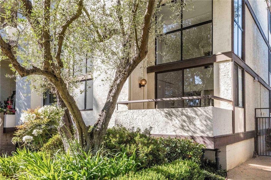 This two-story townhome-like end unit features two bedrooms, 2 bathrooms.  Spacious light-filled living room and dining room with soaring ceilings, fireplace, patio off living room.  Hardwood floors, carpeting.  The kitchen includes a stainless steel refrigerator and stove/range, generous cabinet storage.  The first floor has one bedroom with double closets; 3/4 bathroom.  The top level features a loft bedroom with lattice, large walk-in closet, full bathroom, and laundry closet with washer/dryer.  Home features an energy efficient Daikin unit - for cooling & heating comfort.  Subterranean tandem parking for 2 cars.  Storage cabinet is located in the community closet.  Located in the "heart of the Peninsula", this Peacock Ridge complex is located at the end of the cul-de-sac.  Common area entry, a heated pool and spa.  Ideal, convenient location near Peninsula Center, shopping, restaurants, schools.