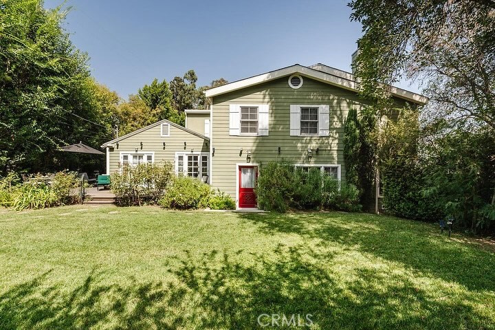 Welcome home to this exquisite Cape Cod Traditional 4 bed, 4 bath residence on an oversized flat lot in the coveted Hollywood Hills! Character and charm abound as you step into an expansive living room with rustic hardwood floors, wood burning fireplace, recessed lighting and reading area. The open and airy eat-in kitchen has ample storage and counter space plus farmhouse sink, Viking double ovens and stainless steel appliances. The kitchen opens onto a spacious formal dining room with direct access to the outdoors perfect for outdoor dining and entertaining. Two nicely proportioned guest bedrooms and bath also located on the first level. Head upstairs to an open work/lounge/TV area, an expansive Primary Suite with luxurious ensuite bathroom, double walk-in closets and a private balcony with views of the Hollywood Sign. An additional guest bedroom with ensuite bathroom also located on the second level. Make guests feel right at home or create your new home office space in the separate guest suite located at basement level, plus attic for storage. Step outside to putt around in your personal putting green or do some gardening in the raised flower beds. Huge grassy flat yard with plenty of room for pool or play, gated and landscaped for ultimate privacy and serenity. Rare find in a top notch location, a must see!