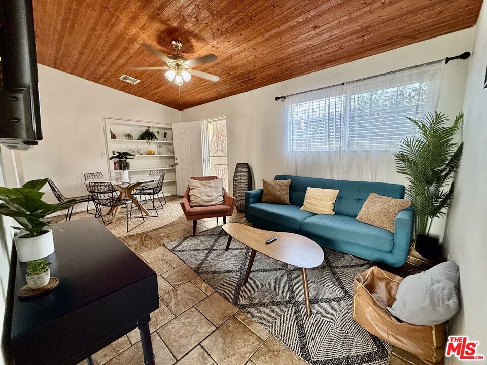 Private and gated NoHo compound consisting of 3 units on an expansive flat lot. The front, street-facing unit has a storefront vibe with high ceilings, slab floors, lots of storage space, a half bathroom, and a separate utility room. It's an open canvas for your creative endeavors. The middle unit has 3 bathrooms, a full bath, an updated kitchen, custom finished ceiling, newer flooring, in move-in condition, with two separate entrances and a rear covered patio for entertaining. The stand-alone rear unit is located in the middle of the lot with an open living area, kitchen, and full bath, one bedroom with a converted closet, serving as a mini music studio, also has it's own washer and dryer. At the rear of the lot, under a spreading oak tree, is a large bonus workshop that could serve any number of purposes; let your imagination take over. Sited on a park-like RD1.5 lot, this property has endless potential for creatives or future development. All units will be delivered vacant at COE.