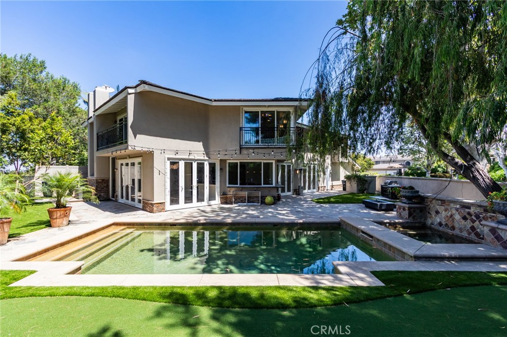 Leave beautifully inside the Gated Guarded Big Canyon on a large corner lot with a premium location influenced by a renowned on golf course area. Entering the home through the exterior gate and walking through the atrium gives a feeling of luxury even before you enter the custom glass front doors. Marble floors reflect tall ceilings from the abundant natural light flowing in from the floor to ceiling windows. The living room flows into the formal dining room adjacent to a modern kitchen with gourmet appliances. Wide open views from all angles show the pool, spa and BBQ , Fire Pit in spacious back and side yards. With one bedroom on the main floor and the other three on the second level, the home is versatile in how they can be used. Fashion Island, with its upscale amenities is basically across the street and the famous beaches and harbors are right down the road making this home a great abode to experience the best in coastal living and all its aspects. property with new paint, new Modern custom chandelier, BBQ Island, firepit and Three hole putting green,