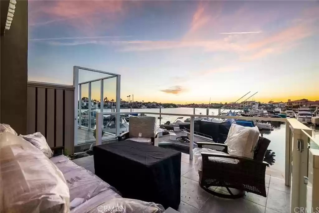 Welcome to this completely remodeled waterfront 2 bedroom condo with 25 ft boat slip and incredible views! This spacious home is bright and open and has been tastefully remodeled with luxury vinyl flooring, custom LED lighting that illuminates under the cabinetry, dual pane windows, remote control shades, Mitsubishi A/C and heaters in both bedrooms and living room. This luxurious kitchen boasts quartz countertops with high end Sub Zero and Wolf appliances, induction range and custom electronic hood from Italy. Relax in this spacious living room with custom fireplace or step out to the large patio with amazing Harbour views. Upstairs the primary bedroom boasts stunning views of the Harbour and a beautiful bathroom with dual sinks and an oversized walk-in shower. There is a secondary primary suite finishing the upstairs along with the included washer and dryer. The detached 2-car garage has custom overhead storage that is approx. 20x20 ft. and peak heights up to approx. 10 ft. with pull-down ladder. All appliances are included along with the mounted TV’s. The unit is near the community pool and HOA fees are included. The views are endless and the sunsets from the master suite and living room and their patios are incomparable!! Don’t Miss Out!!!