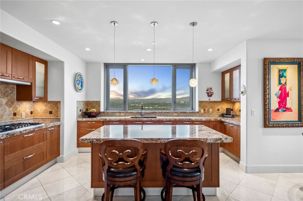 Modern Luxury with Panoramic Views – Plaza Irvine Corner Unit
Welcome to 5114 Scholarship, a rare 11th-floor corner residence in the prestigious Plaza Irvine. This 2-bedroom + den, 2.5-bath home offers over 2,050 square feet of refined single-level living with unobstructed 180-degree views—stretching from Saddleback Mountain to the Newport Coast and Catalina Island.
Designed for comfort and sophistication, the unit features marble flooring throughout, a grand double-door entry, and an open-concept layout ideal for both relaxing and entertaining. The gourmet kitchen includes Viking appliances, granite countertops, and Italian Snaidero cabinetry. Automated Lutron shades and lighting add convenience and ambiance.
The spacious primary suite includes a spa-like bath with a jetted tub, walk-in shower, dual vanities, and a large walk-in closet. A flexible den space can serve as an office, media room, or dining area. A separate laundry room with built-in storage, an ensuite guest bedroom, and a large wraparound balcony complete the interior.
Two side-by-side parking spaces and a climate-controlled storage locker are included.
Resort-style amenities: junior Olympic pool, lap pool, spa, fitness center, yoga room, club and billiards rooms, BBQ areas, conference rooms, and 24/7 concierge and security staff.
Prime location near John Wayne Airport, UCI, Fashion Island, and Newport Beach.